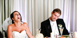 Bride and groom laughing funny wedding speeches